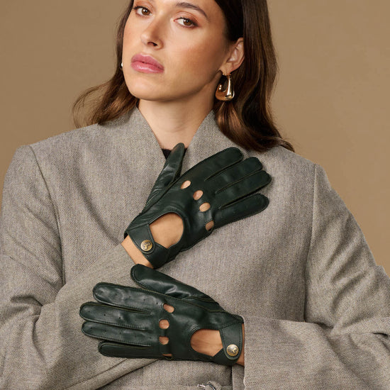 Dark green leather driving gloves with studded button details and finger cutouts