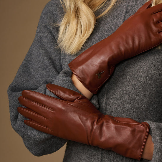 Extra-long cognac leather gloves with smooth cuffs and stitched finger seams