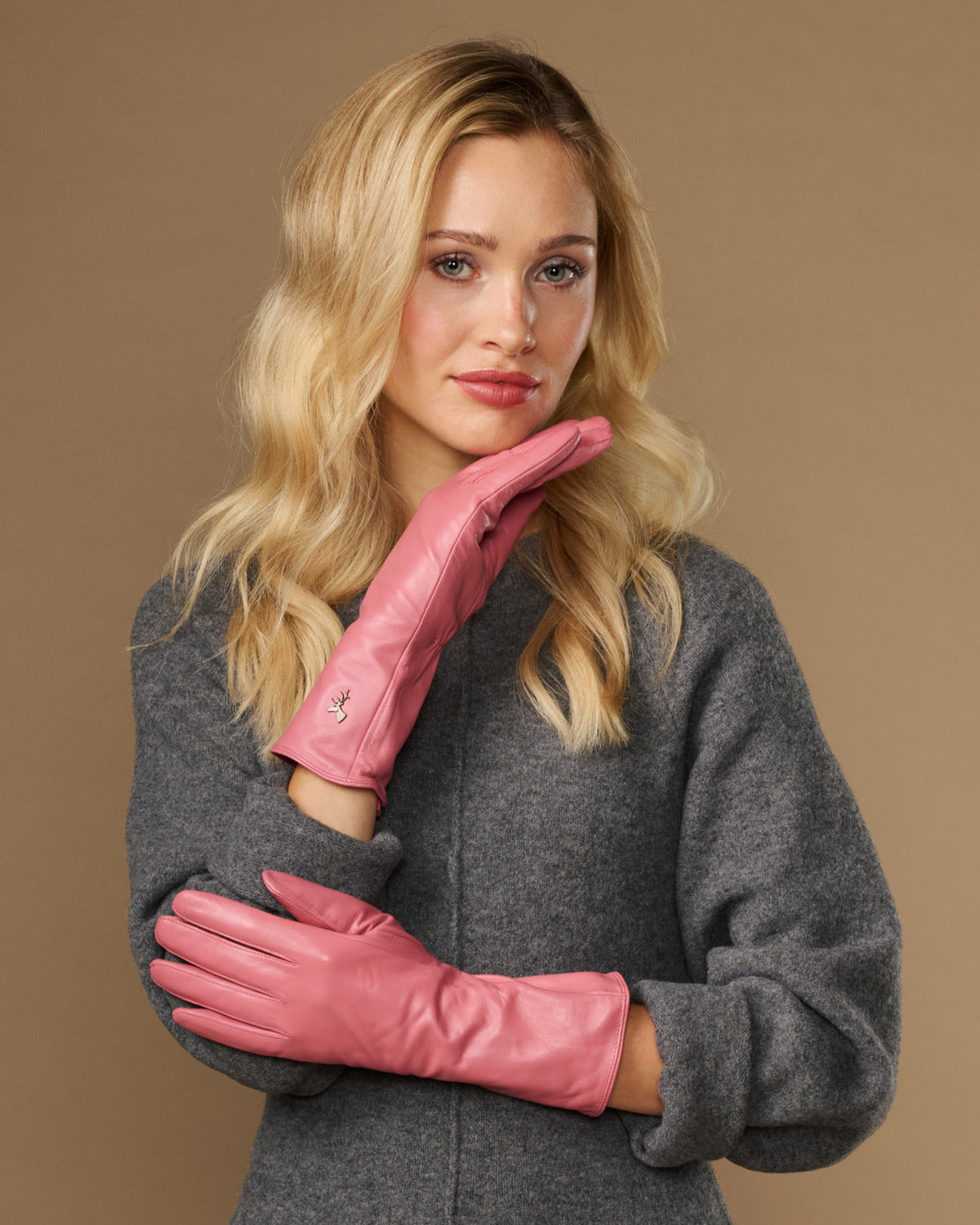 Pink leather gloves with long cuff and textured wrist seam, touchscreen fingertips