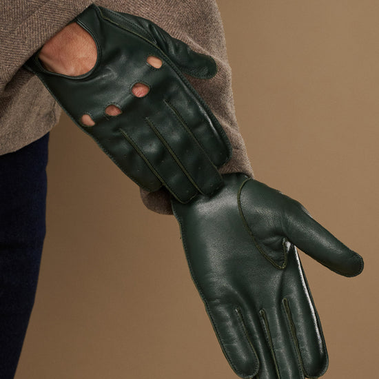Dark green lambskin driving glove with stitched fingers and curved palm seam