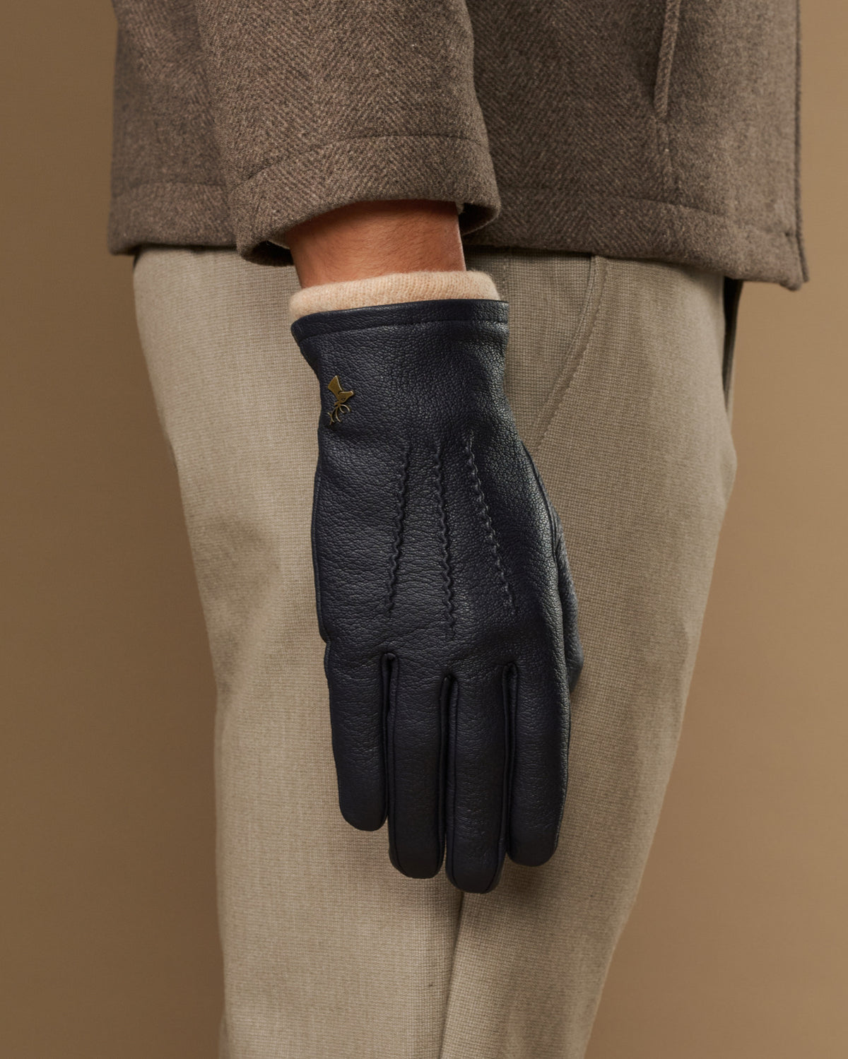 Men's navy leather gloves with wool lining, cuff showing soft inner knit