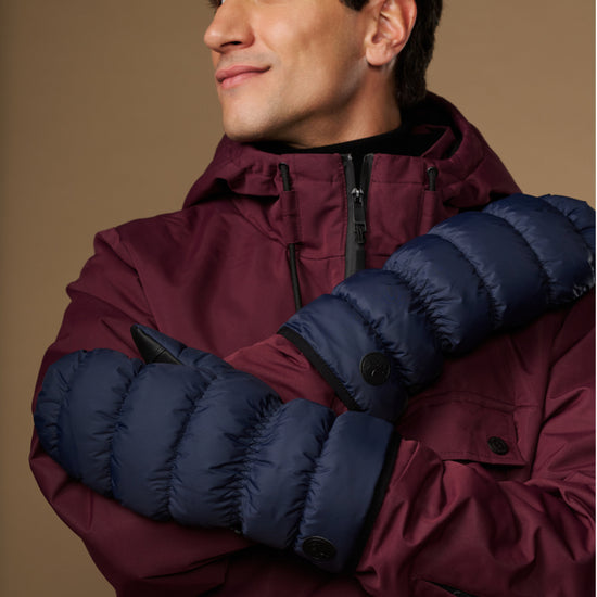 Blue padded mittens with logo buttons on the back of the hand