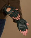 Dark green fingerless lambskin gloves showing perforated backs and stitched palm padding