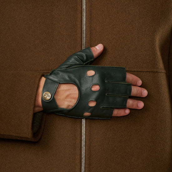 Dark green fingerless lambskin glove with perforations and a buttoned wrist strap
