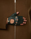 Dark green fingerless lambskin glove with perforations and a buttoned wrist strap