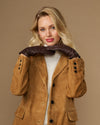 Brown fleece-lined leather gloves held up near coat hood, cuffs visible