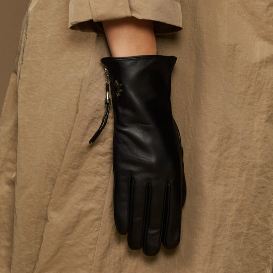 Black lambskin leather glove with side zipper, hanging display