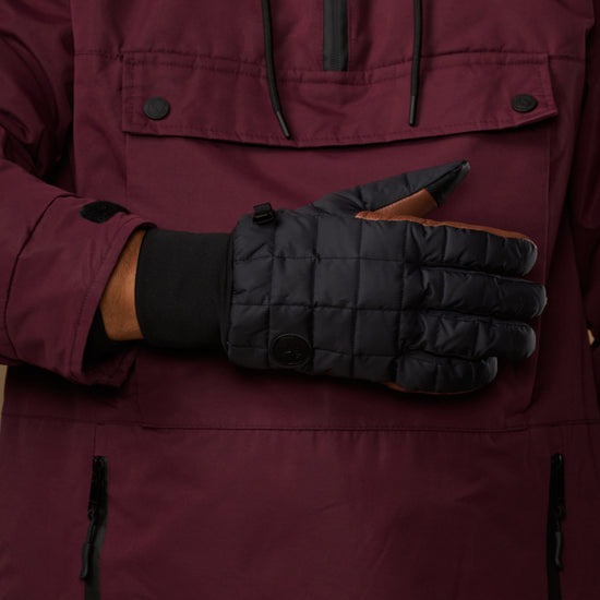 Close-up of men's quilted touchscreen gloves, dark gray with brown details