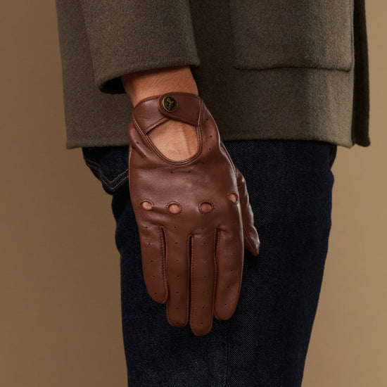Brown leather driving gloves with elastic wrist and reinforced palm stitching