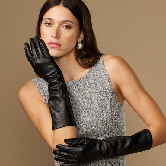 Black below-elbow leather gloves with touchscreen fingertips, glossy finish, ruched cuff