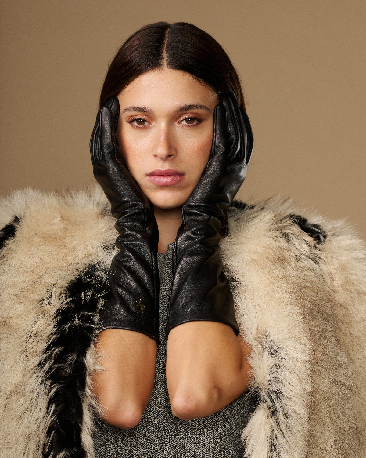 Pair of black below-elbow leather gloves with ruched cuffs, glossy finish, touchscreen fingertips