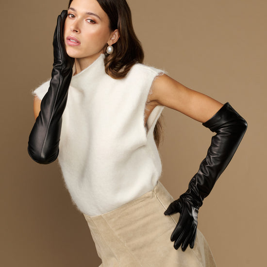 Black lambskin leather opera gloves with silk lining, long cuffs in hand pose