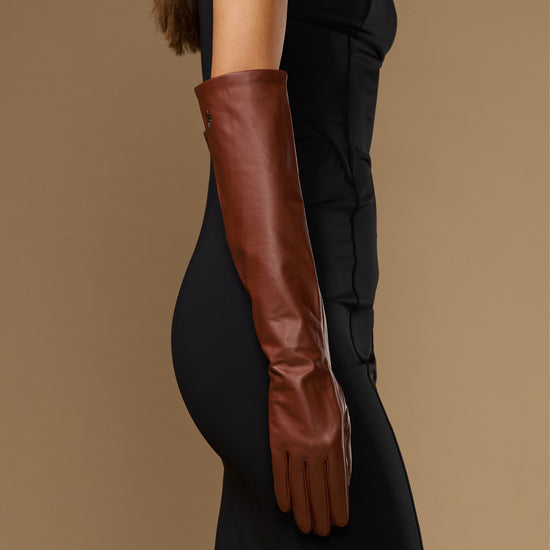 Chocolate brown leather elbow gloves shown on arm with wrist-to-elbow length