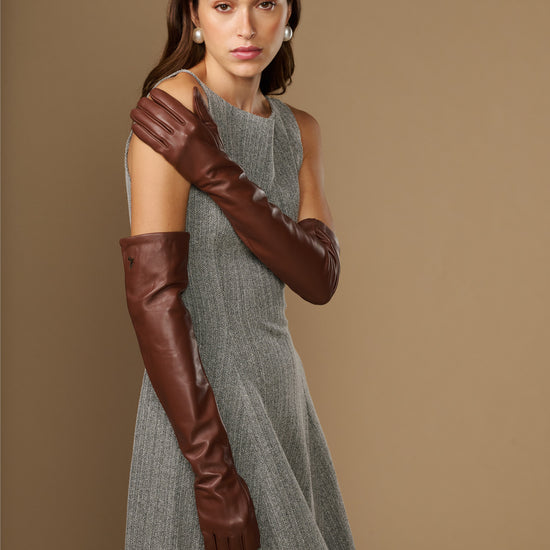 Women's chocolate-brown lambskin leather gloves, side view with long cuff and tight fit