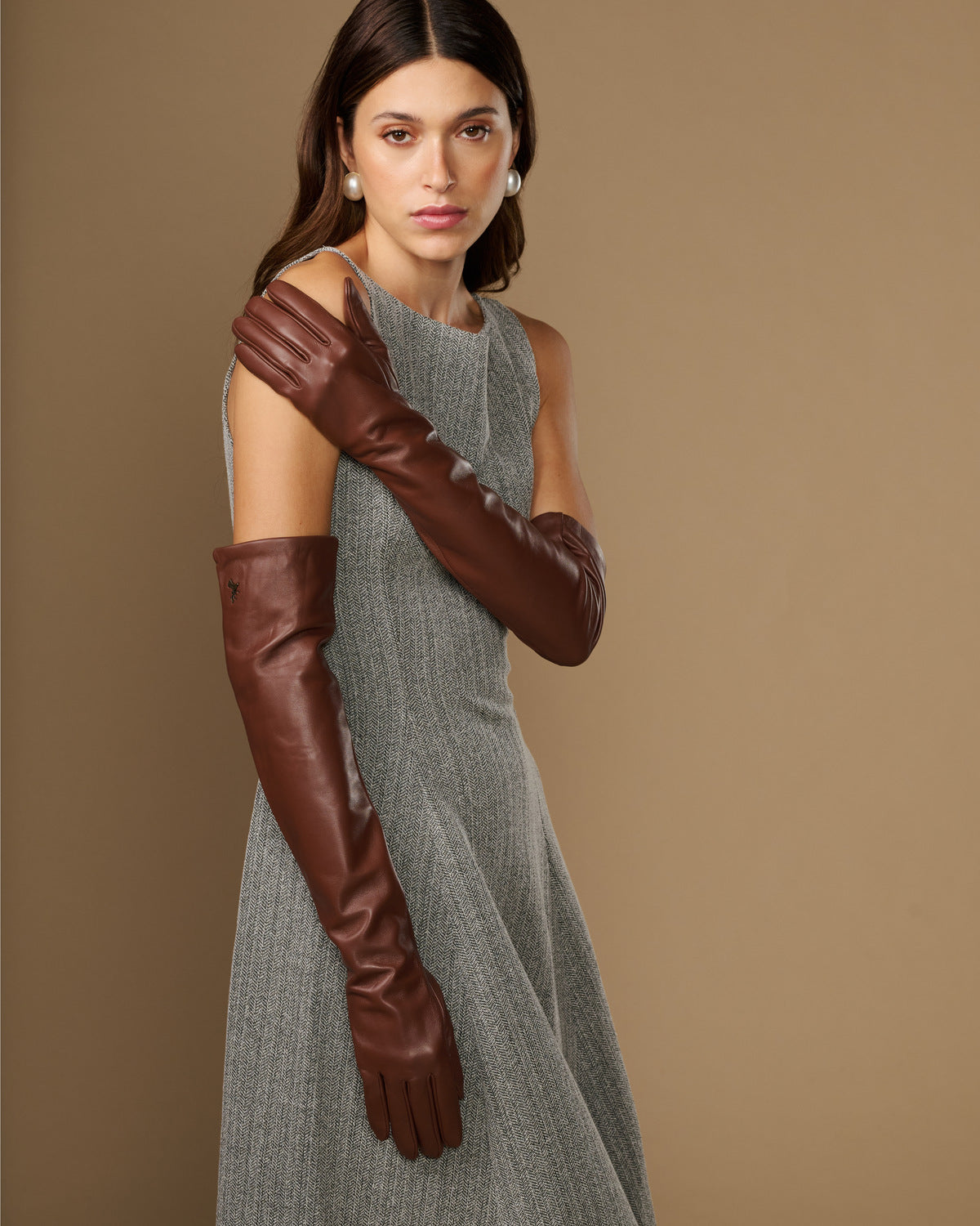 Women's chocolate-brown lambskin leather gloves, side view with long cuff and tight fit