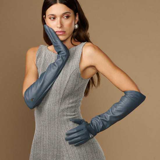 Dark blue elbow-length leather gloves on model, cuff and hand details