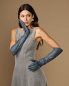 Dark blue elbow-length leather gloves on model, cuff and hand details