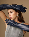 Women's blue leather elbow gloves with long arm coverage and seam details