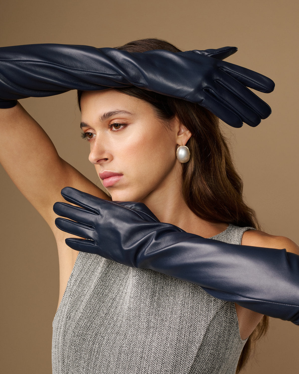 Women's blue leather elbow gloves with long arm coverage and seam details