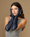 Women's blue leather elbow gloves with neat wrist cuff and close-up hand styling