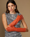 Women’s orange below-elbow leather gloves with smooth lambskin finish and wrist cuff