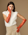 Women’s orange leather elbow gloves, smooth finish, covering hands to mid-forearm