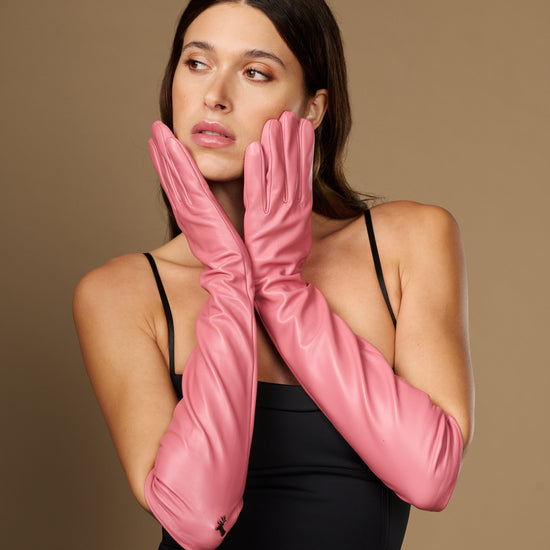 Pink silk-lined leather elbow gloves with full-finger coverage and tapered wrist