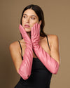 Pink silk-lined leather elbow gloves with full-finger coverage and tapered wrist