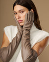 Front view of taupe leather gloves with long cuffs and fitted finger panels