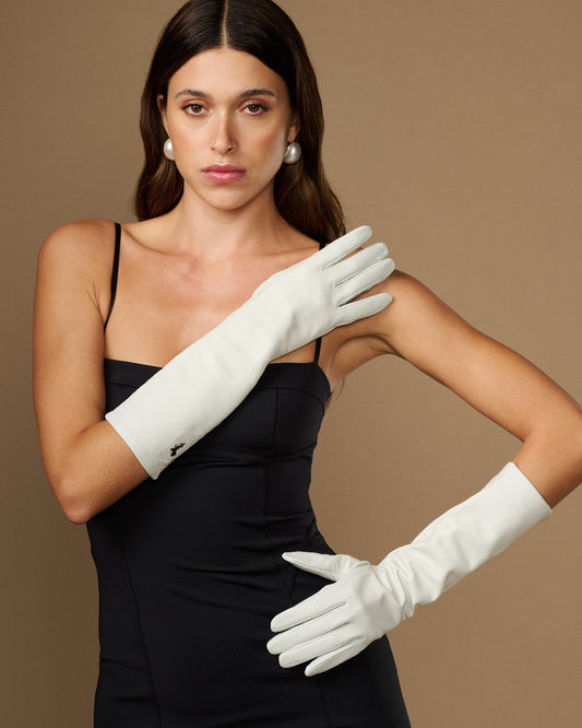 Women’s white lambskin leather below-elbow gloves, silk-lined, worn together on hands