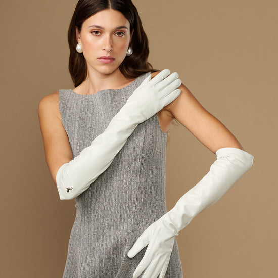 White elbow-length leather gloves with smooth finish and fitted finger shape