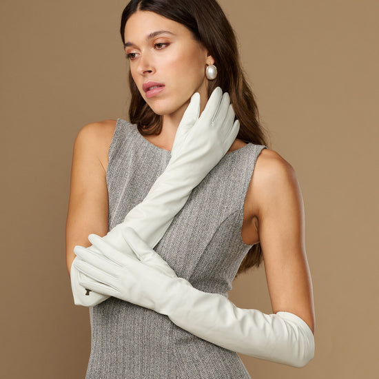 White elbow-length leather gloves with clean stitching lines and snug wrist cuff