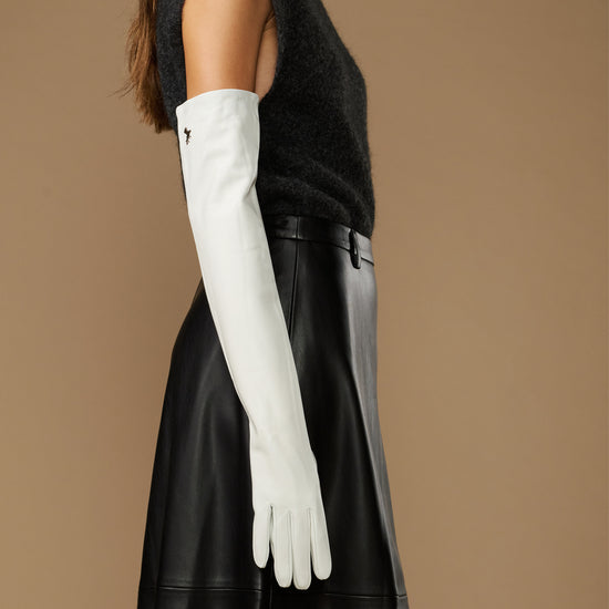Women's white leather gloves with long fitted cuffs, smooth matte finish