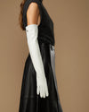 Women's white leather gloves with long fitted cuffs, smooth matte finish
