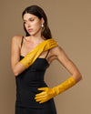 Yellow leather below-elbow gloves with close fit, long cuffs, and smooth knuckle detail