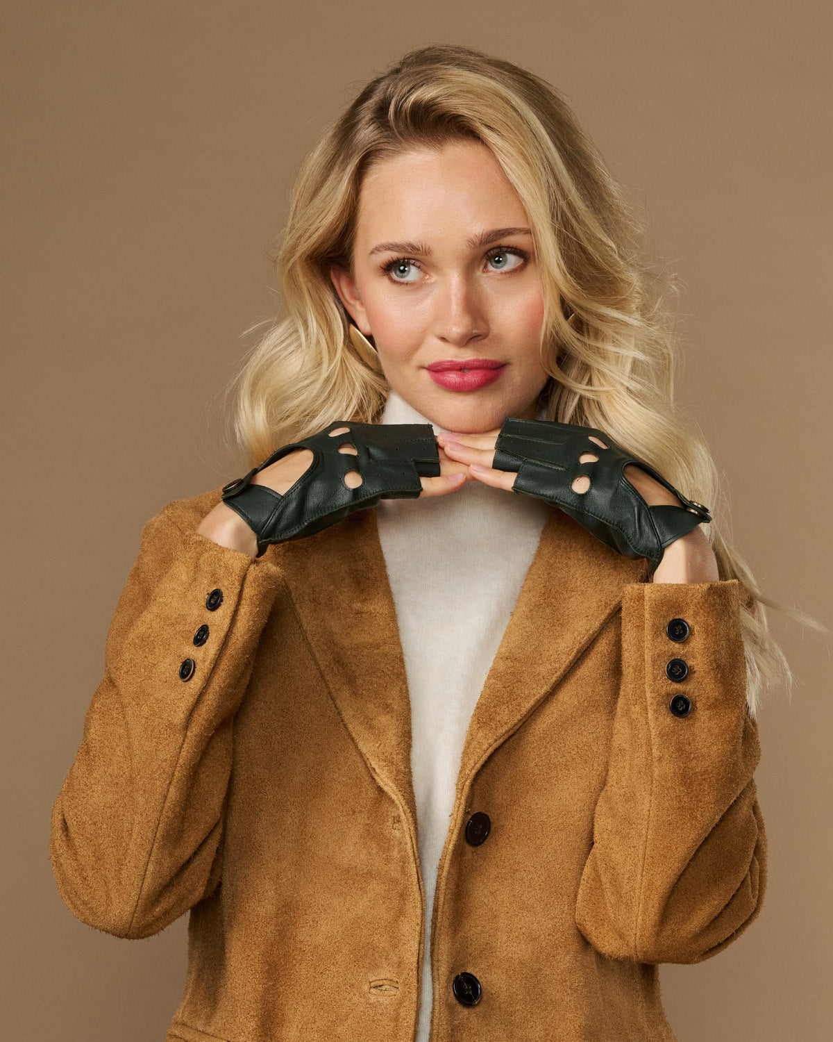 Dark green fingerless lambskin driving gloves with button detailing on cuffs