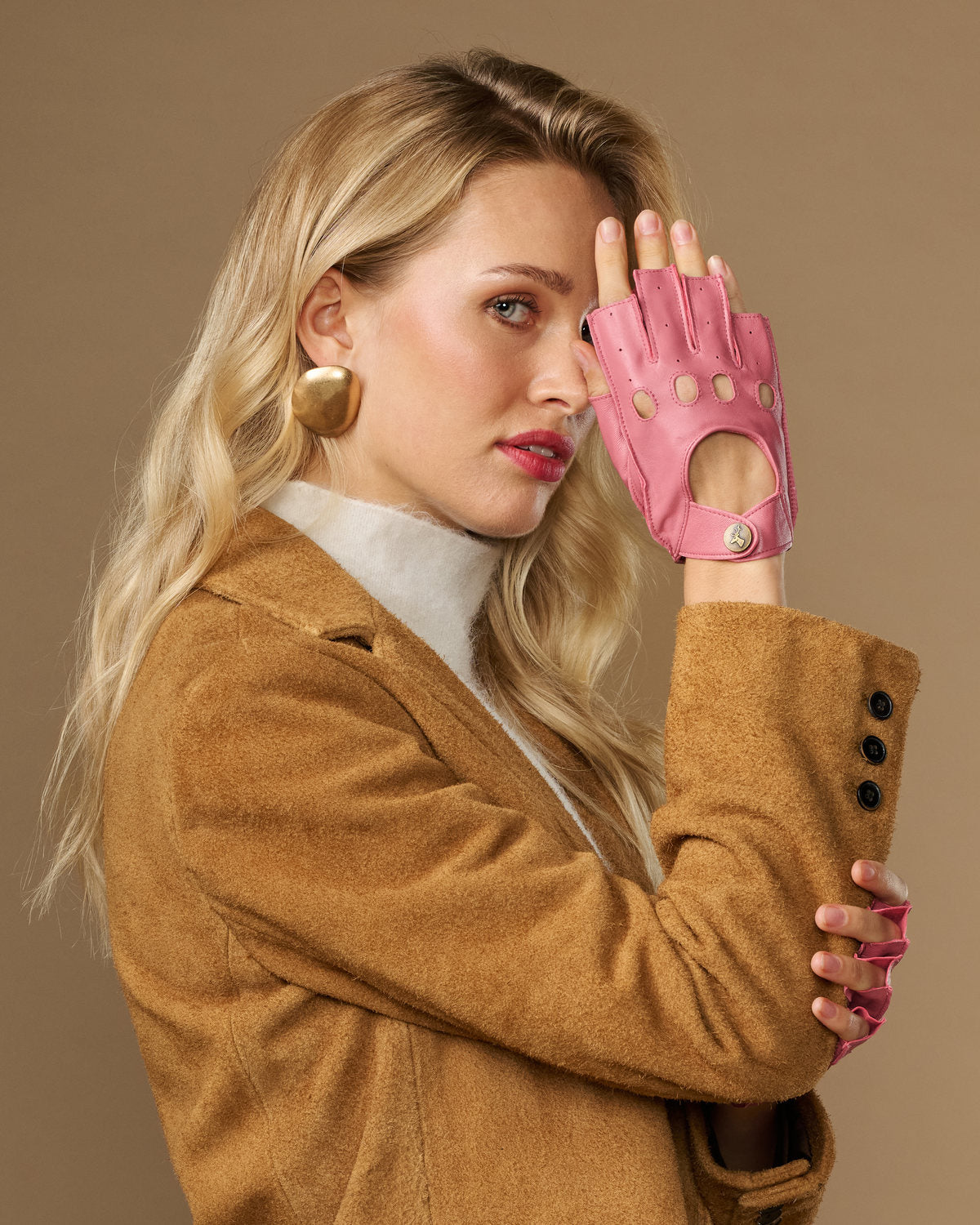 Pink fingerless lambskin driving gloves, side view with open fingers and snaps