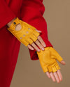 Yellow long fingerless leather driving gloves with thumb opening and button-cuff straps